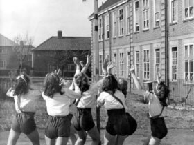 A circa 1950s photo of a group of girls looking upwards while playing netball