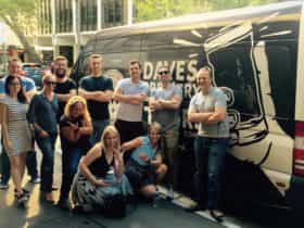 Beer tour participants in front of the Dave's Brewery Tour bus