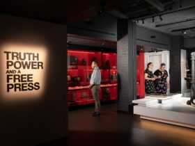 MoAD’s Truth Power and a Free Press exhibition entry with three visitors looking at displays